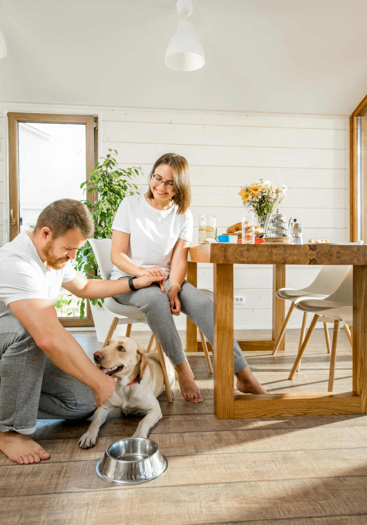 Young couple with dog at home | Sheridan Floor To Ceiling